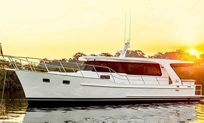 An elegant boat charter in Sydney on a classic gentleman's cruiser with traditional lines & teak interiors.