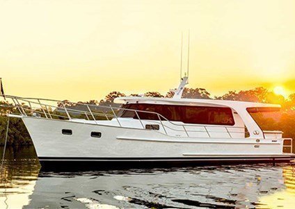 An elegant boat charter in Sydney on a classic gentleman's cruiser with traditional lines & teak interiors.
