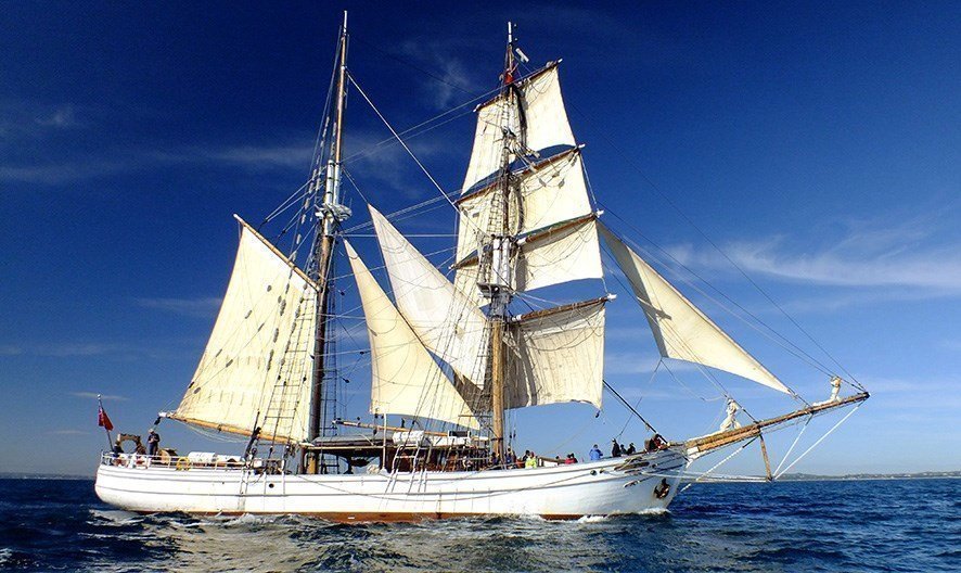 Experience the traditional cargo carrying sailing ship-Soren Larsen under the beautiful blue sky.